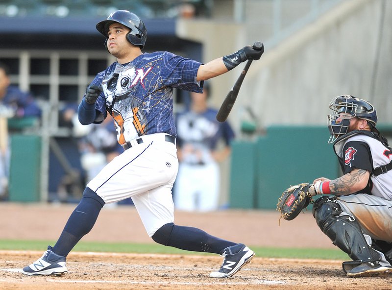 NWA Democrat-Gazette/ANDY SHUPE Naturals catcher Luis Villegas (left) connects for an RBI double Saturday against the Travelers at Arvest Ballpark in Springdale. Visit nwadg.com/photos for more photographs from the game.