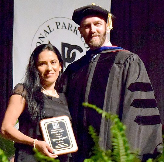 Submitted photo ALL-STAR: National Park College education student Lorena Fitzpatrick, left, was presented the Academic All-Star Award by Wade Derden, vice president for academic affairs, during the college's spring commencement ceremonies May 13 at Bank of the Ozarks Arena.