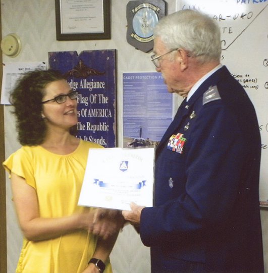 Submitted photo TIGER MOM: Lake Hamilton Junior High library media specialist Jil'Lana Heard, left, received her certificate of appreciation from former Arkansas Wing commander Col. William Akins May 23 in the Civil Air Patrol "Flying Tiger"Squadron's building at Hot Springs Memorial Field. Her son is a participant in CAP's cadet program in Hot Springs.