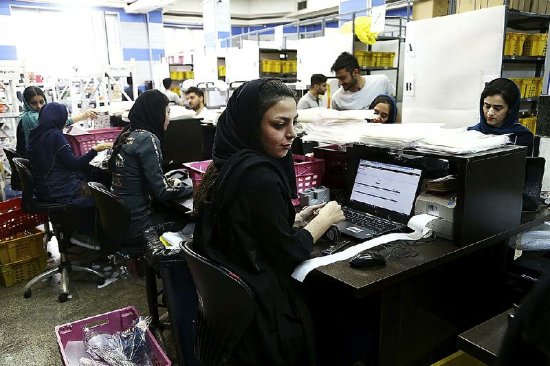 An employee works at the fulfi llment center of the Bamilo online shopping site in Tehran, Iran.