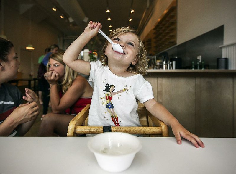 Arkansas Democrat-Gazette/MITCHELL PE MASILUN --6/11/2017--
2 1/2 year old Gemma Benton of Fayetteville enjoys some ice cream at Loblolly's in Little Rock Sunday, June 11, 2017.  The company recently moved into their new storefront in the South Main District of the city, just next to where they were previously located.