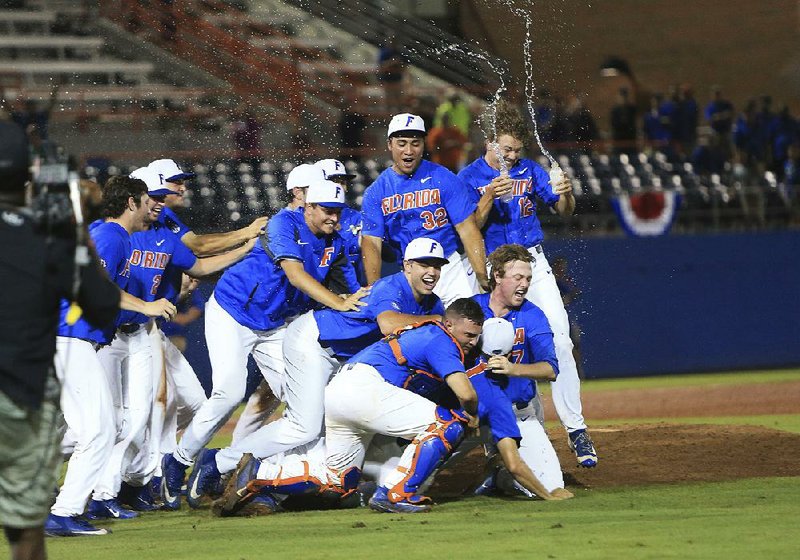 Florida players celebrate after defeating Wake Forest on Monday night to earn a spot in the College World Series for the third consecutive season and the sixth time in eight seasons.