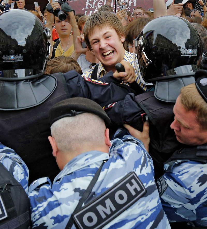 Russian riot police block protesters Monday during a demonstration in downtown Moscow.