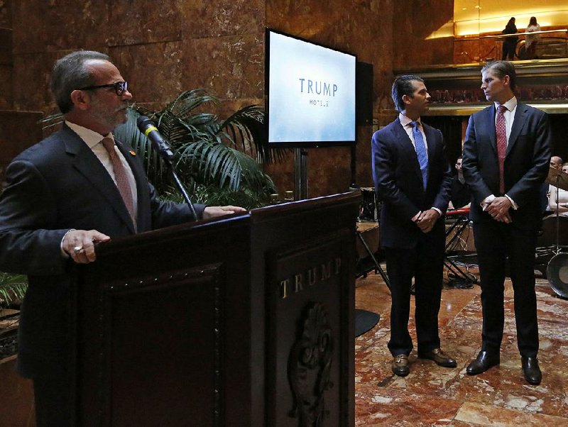 Trump Hotels CEO Eric Danziger (from left), joined by Donald Trump Jr. and Eric Trump, speaks June 5 during an event at Trump Tower in New York.