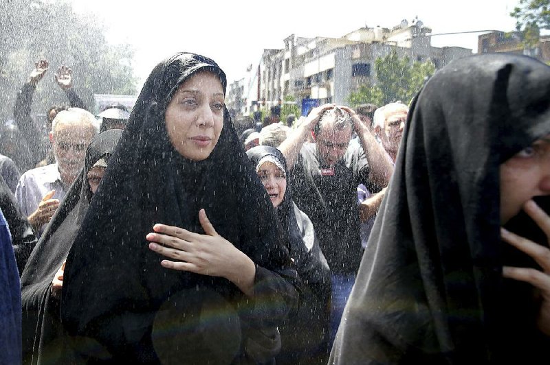 Iranians on Friday attend a funeral for victims of an Islamic State attack in Tehran. The group has stepped up its attacks around the world during the Muslim holy month of Ramadan.