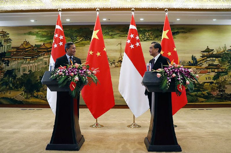 Singaporean Foreign Minister Vivian Balakrishnan (from left), after meeting Monday with Chinese counterpart Wang Yi in Beijing, called his country a “strong believer and supporter” of China’s trade and infrastructure initiative.