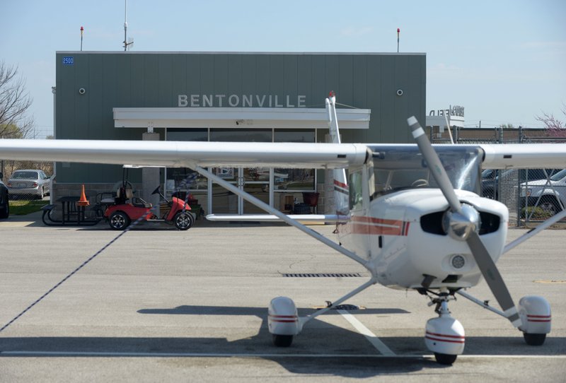 A plane used by Summit Aviation sits in front of the Summit Aviation office Monday, March 20, 2017, at Bentonville municipal airport. Plans for a new Flight Center on the Northwest side of the runway, which will become the main entrance to the airport, include space for some of Summit Aviation's operations, among other amenities. 