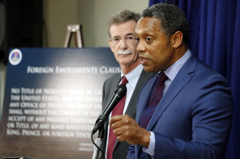 Maryland Attorney General Brian Frosh listens at left as District of Columbia Attorney General Karl Racine answers a question during a news conference in Washington, Monday, June 12, 2017, to announce what they call a &quot;major lawsuit&quot; against President Donald Trump. The lawsuit cites Trump's leases, properties and other business &quot;entanglements&quot; around the world as the reason for the suit, saying those posed a conflict of interest under a clause of the Constitution. (AP Photo/Alex Brandon)
