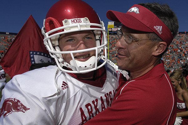 Arkansas quarterback Mitch Mustain celebrates with offensive coordinator Gus Malzahn after Arkansas beat No. 2 Auburn 27-10 in a college football game on Saturday, Oct. 7, 2006 in Auburn, Ala. Malzahn coached Mustain in high school. (AP Photo/Todd J. Van Emst)
