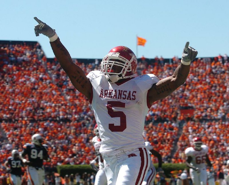 Arkansas running back Darren McFadden celebrates after his 64-yard touchdown run in the second quarter of the Razorbacks’ 27-10 victory at Auburn in 2006. McFadden rushed for 145 yards, and fellow sophomore Felix Jones added 104 yards and a score for the Hogs, who went on to win the SEC West Division title.