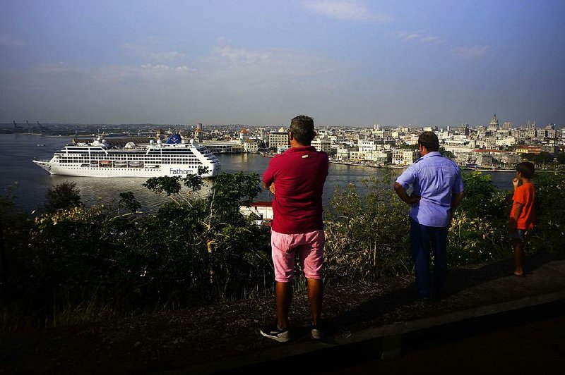 People watch the Carnival Adonia cruise ship arrive in Havana in May 2016. An anonymous White House official said President Donald Trump planned to announce his new policy on Cuba on Friday in Miami but had yet to decide on all the details. 