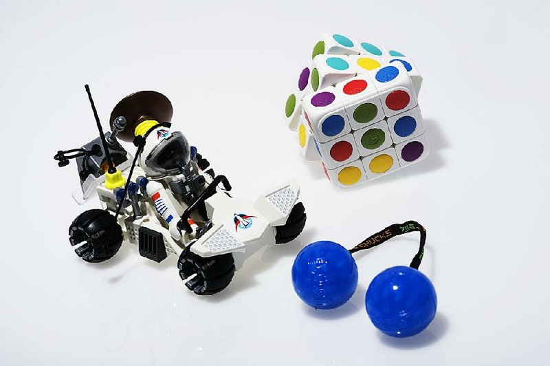 It's smart to pack a few low-tech toys - such as (clockwise from left) Playmobil's Space Exploration set, Cube-tastic or Thumb Chucks - for times when you can't use electronics. 