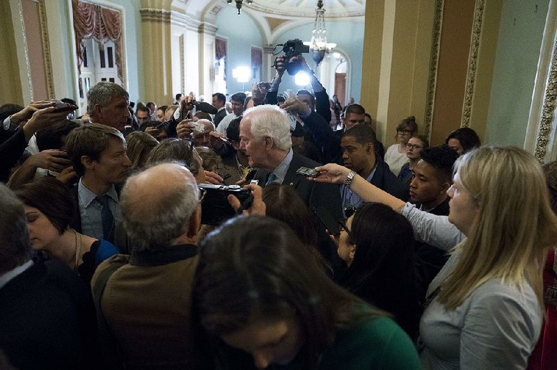 Sen. John Cornyn, R-Texas, faces a Capitol Hill hallway full of reporters earlier this month.