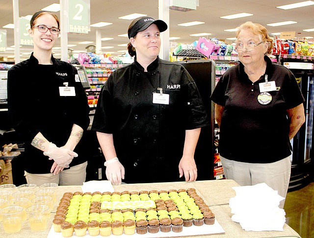 These Harps&#8217; employees &#x2014; Robin Fish, Kristen Duncan and Rita Hill &#x2014; welcome customers to the new Harps store in Lincoln with a cupcake and drink.