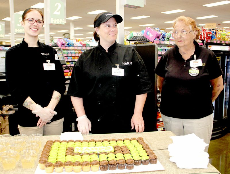 These Harps&#8217; employees &#x2014; Robin Fish, Kristen Duncan and Rita Hill &#x2014; welcome customers to the new Harps store in Lincoln with a cupcake and drink.