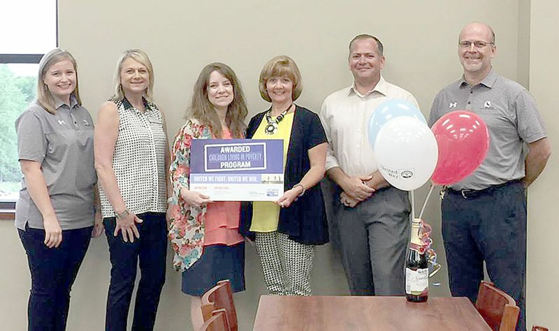 COURTESY PHOTO Representatives of Lincoln Consolidated School District accept a $110,000 grant from United Way of Northwest Arkansas. The district will receive $60,000 the first year and $50,000 the second year. Dallas Muss, vice president of gift-in-kind operations, presented the grant to Lincoln on behalf of United Way.