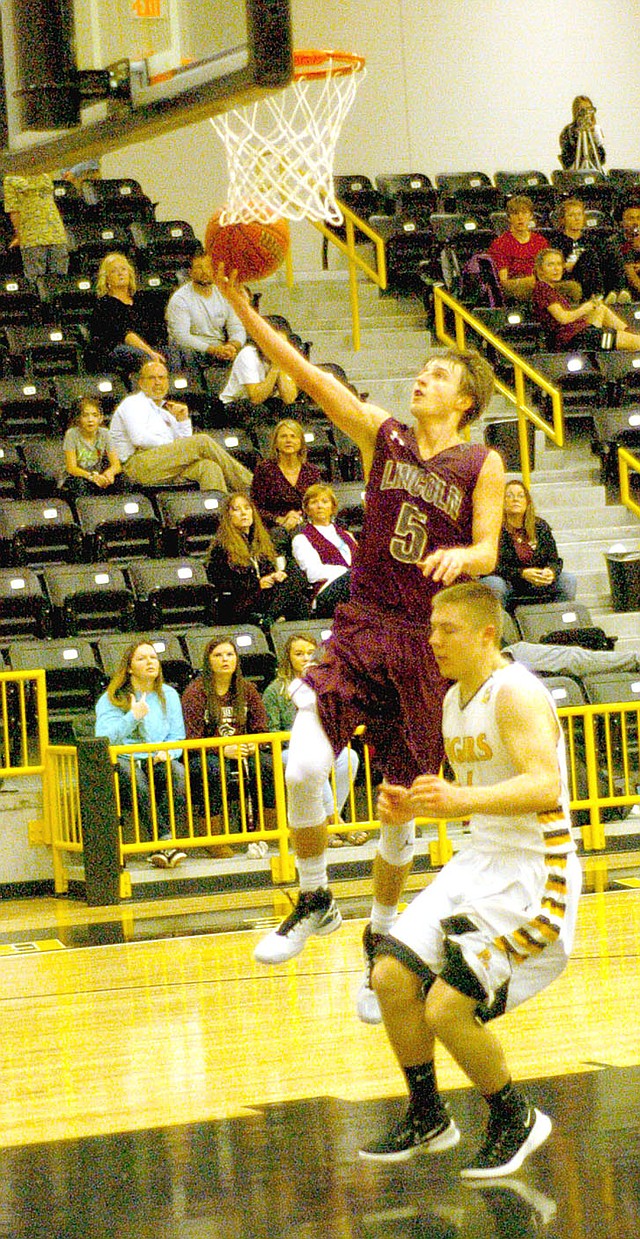 MARK HUMPHREY ENTERPRISE-LEADER Lincoln guard Bryce Means scores a layup after stealing the ball and beating Prairie Grove&#8217;s Zeke Laird to the hoop. The Tigers beat the Wolves Jan. 11, but a few weeks later Lincoln evened the season series with an improbable, 53-52, comeback win at home. Means accepted a basketball scholarship from Bacone College of Muskogee, Okla., June 1.