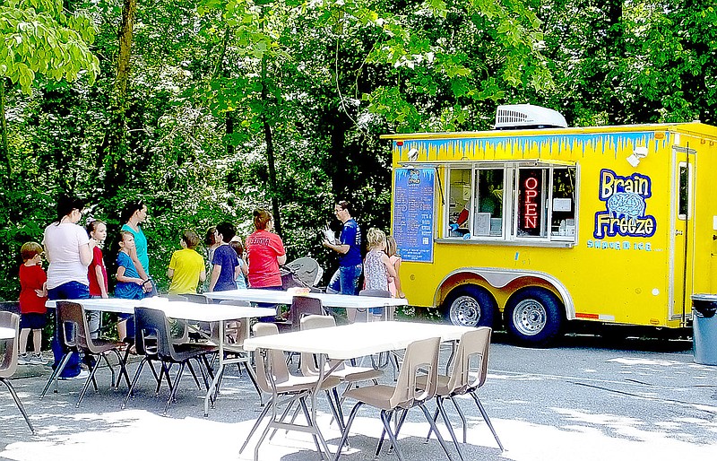 Lynn Atkins/The Weekly Vista Snow Cones were a big hit at the Bella Vista Library Summer Reading program kick-off on Thursday.