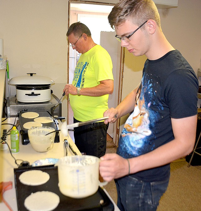 Janelle Jessen/Herald-Leader Samuel Hassett cooked pancakes on the griddle inside the Word of Life Fellowship during the New Beginnings Pregnancy Services fundraiser on Saturday morning. The event included a 5K race, 1 mile walk and 20 mile cycle, as well as a pancake breakfast.