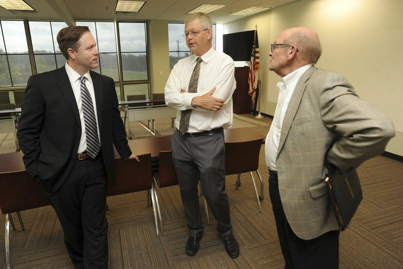 NWA Democrat-Gazette/ANDY SHUPE Nelson Peacock (left) speaks Tuesday with Rob Smith, and Scott Van Laningham, both of the Northwest Arkansas Council, after being announced as the new president and CEO of the council.