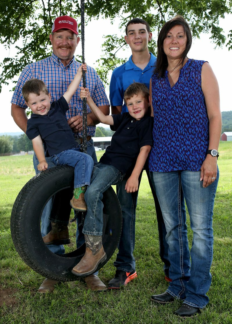 NWA Democrat-Gazette/DAVID GOTTSCHALK Allen and Cindy Moore stand Tuesday with their sons Hudson (from left), 2, Kipton, 6, and Cameron, 15, on at the more than 500 acre Moore Valley Farms near Lincoln. The family was named the 2017 Washington County Farm Family of the Year.