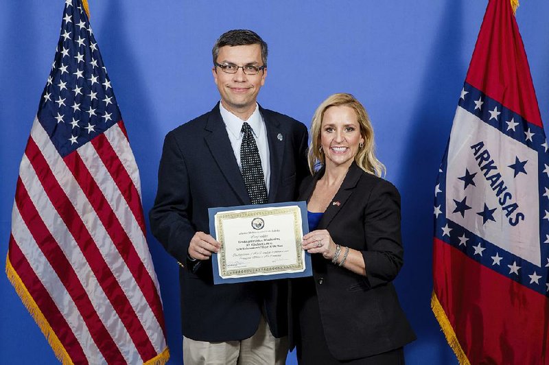 This 2016 photo provided by Karen E. Segrave shows Newport Police Lt. Patrick Weatherford accepting the 2016 Jackson County Law Enforcement Officer of the Year award from Arkansas Attorney General Leslie Rutledge in Little Rock, Ark. 