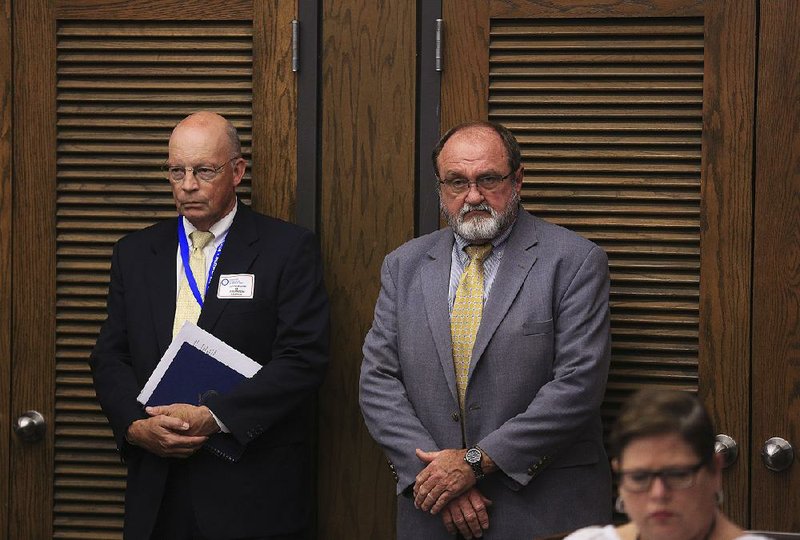 In this 2015 file photo Little Rock School District Superintendent Baker Kurrus (left) and Pulaski County Special School District Superintendent Jerry Guess listen during a state Board of Education meeting as administrators from academically distressed schools give reports to the board. 