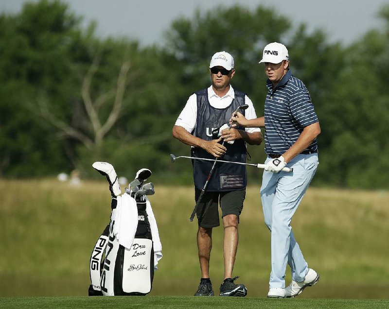 Davis Love III (left), the 1997 PGA Championship winner, is caddying for his son, Davis Love IV, this week at the U.S. Open. The younger Love shot a 1-under 71 in Thursday’s first round.