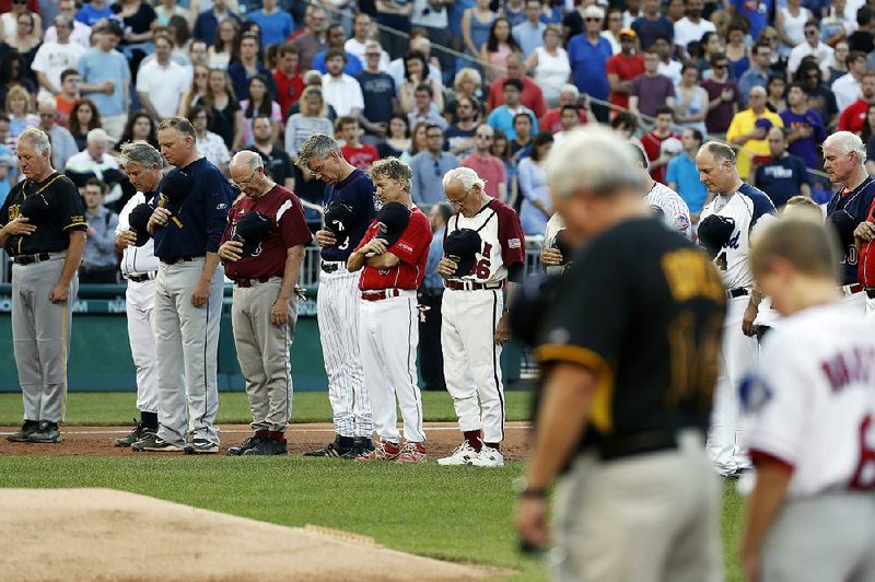 Republicans and Democrats observe a moment of silence for Wednesday’s shooting victims, as the lawmakers take the field Thursday night at Nationals Park in Washington for their annual charity baseball game.