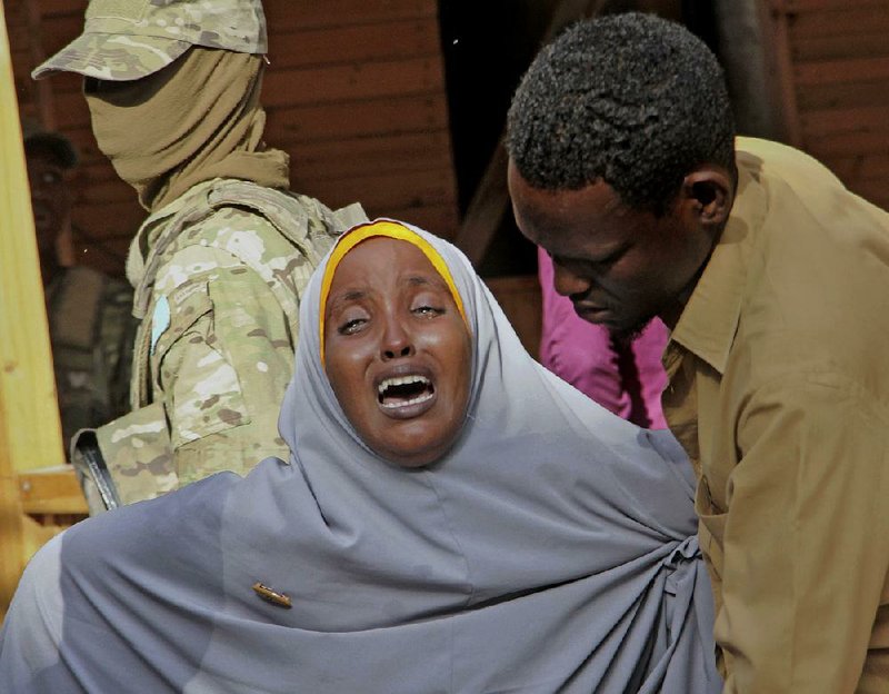 A mother whose daughter was shot in the head by Islamic extremists during an attack on a restaurant grieves Thursday in Mogadishu, Somalia. Al-Shabab claimed responsibility for the attack, which killed 31 people.