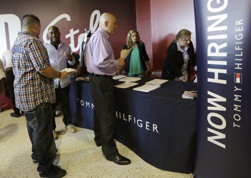 In this June 10, 2015, file photo, job seekers attend a job fair in Sunrise, Fla. On Thursday, June 15, 2017, the Labor Department releases weekly jobless claims. 