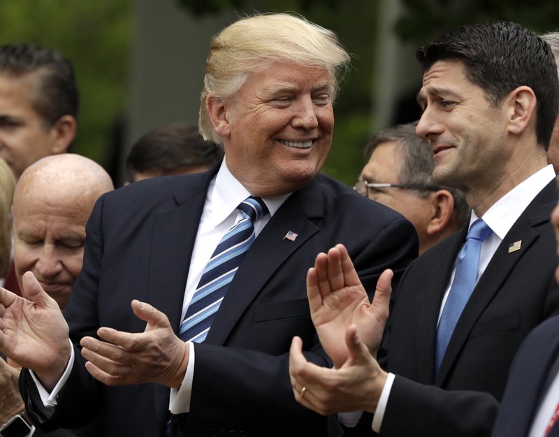 FILE - In this May 4, 2017, file photo, President Donald Trump talks to House Speaker Paul Ryan of Wis. in the Rose Garden of the White House in Washington, after the House pushed through a health care bill. Trump promised to make health care more affordable but a government report finds that out-of-pocket costs _ deductibles and copayments _ would average 61 percent higher under the House Republican bill. (AP Photo/Evan Vucci, File)