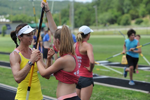 April Steiner Bennett (left), a former Arkansas and Olympic pole vaulter, works with camper Madison Sanders, 15, of Marianna, Friday, June 16, 2017, during instruction for pole vaulters at Ramay Junior High School in Fayetteville. Steiner Bennett and Stacy Dragila, a former Olympic pole vaulter and 2000 Olympic gold medalist, were on hand for two days of intensive instruction for vaulters from elementary to high school.
