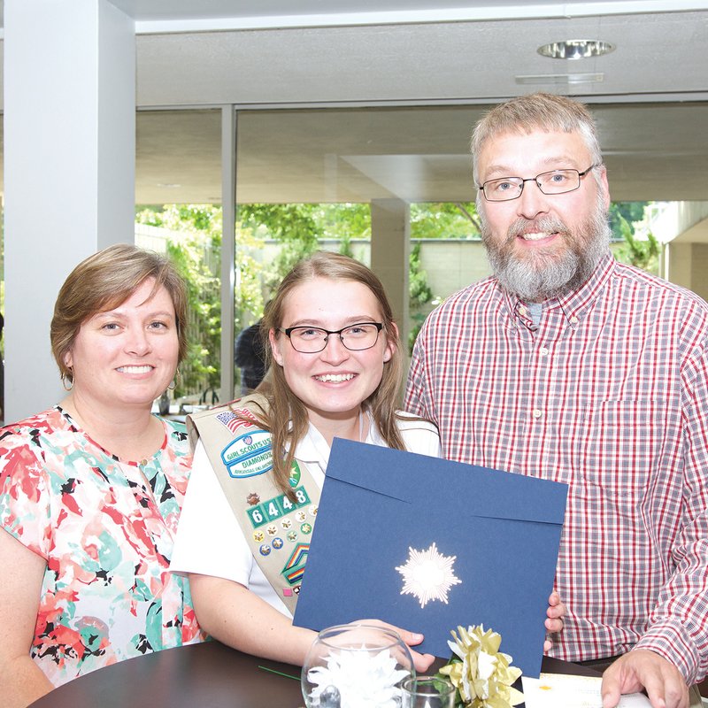 Bailey Money of Searcy, center, displays her Gold Award with her parents, Holly and Don Money, after receiving the honor in a special ceremony June 10 at the Arkansas Arts Center in Little Rock.