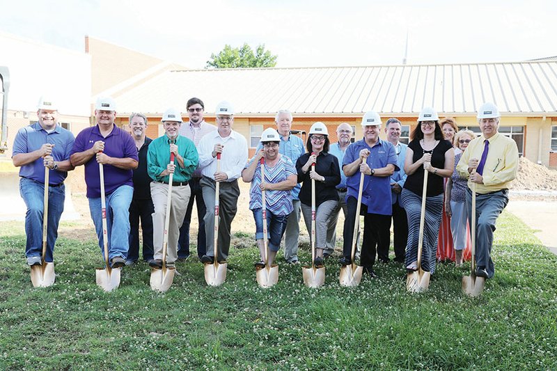 A groundbreaking was held Monday for the Mayflower Elementary School storm shelter. Participating are, front row, from left, Mayflower High School Principal T.J. Slough; school board members Pat Raney, Benji Post, Terry Turner, Delorise Kocher and Sherilee Holland, board president; Mayor Randy Holland; Assistant Middle School Principal Kim Koch; and Superintendent John Gray. In the back row are Jim Houston, a member of the Mayflower Chamber of Commerce Board and the Faulkner County Quorum Court; Eddy York, president of the Mayflower Chamber of Commerce; Dilbert Dawson, chairman of the Mayflower Planning Commission; David Adcock, a member of the Mayflower City Council; Bunny Brown, architect; Barbara Mathes, recorder and assistant to the mayor; and Olive Gray, resident.