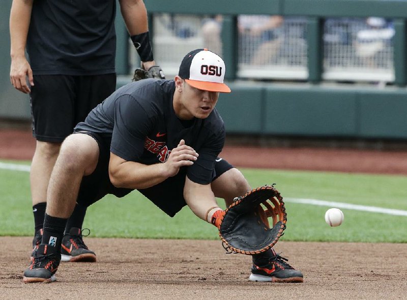 Oregon State’s K.J. Harrison fields a ball during practice Friday in Omaha, Neb. The Beavers (54-4) enter the College World Series today on a 21-game winning streak.