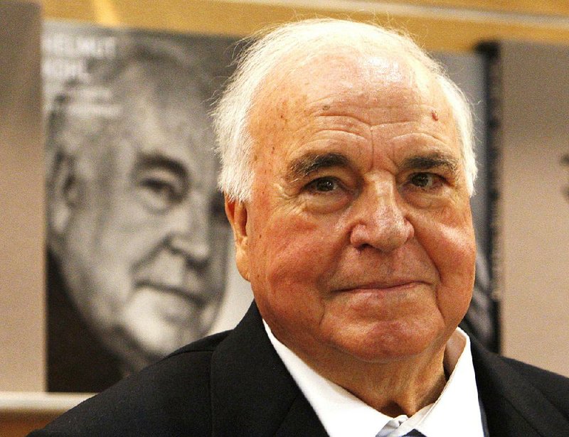 The Oct. 8, 2010 file photo shows former German Chancellor Helmut Kohl talking to visitors and media about a picture book on him that was introduced at the book fair in Frankfurt, central Germany.