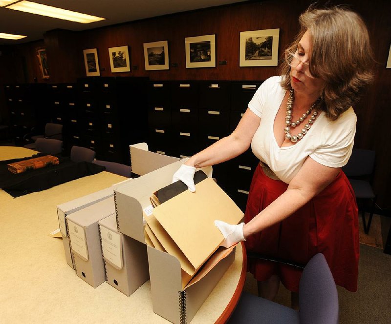 Catherine Wallack, architectural records archivist at the University of Arkansas, Fayetteville and project curator for the Southland College papers, shows a few of the photographs and documents Thursday that are contained in the collection from the former college in rural Phillips County.