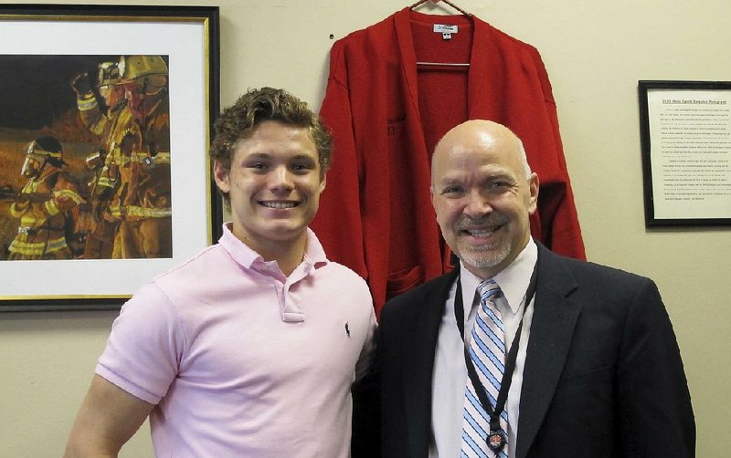 Connor Carrow, 17, poses with Lancaster, N.Y., High School Principal Cesar Marchioli after Carrow received a leadership award at his senior banquet. Carrow, who landed outside the top 10 in his class, wants the school to switch to Latin honors as a better fit with the school’s collaborative and cooperative ideals.