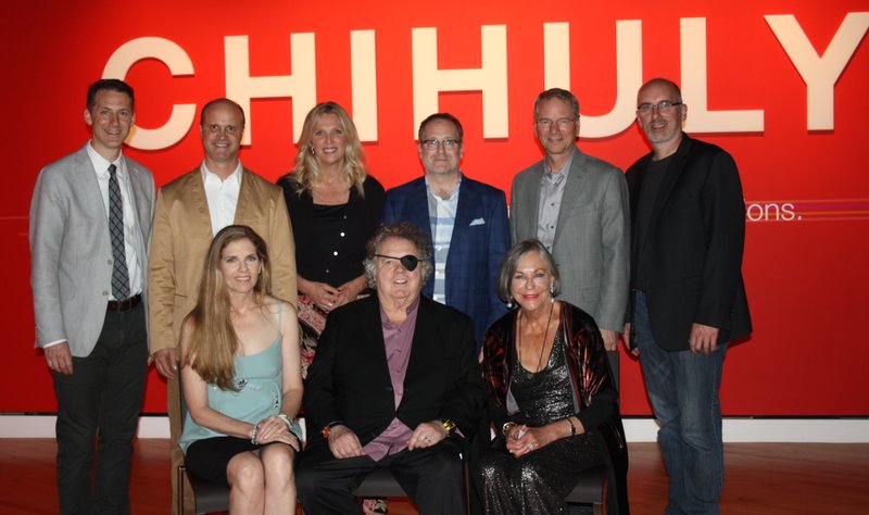 Leslie Jackson Chihuly and Dale Chihuly (seated, from left); Alice Walton, Crystal Bridges Museum of American Art founder and chairwoman; Rod Bigelow, executive director (standing, from left); and Peter West, Britt Cornett, Jay Picard, Michael Tobiason and Scott Lee, all of Chihuly Inc., gather at a sponsors’ preview of the Chihuly exhibition May 27 at the museum in Bentonville.