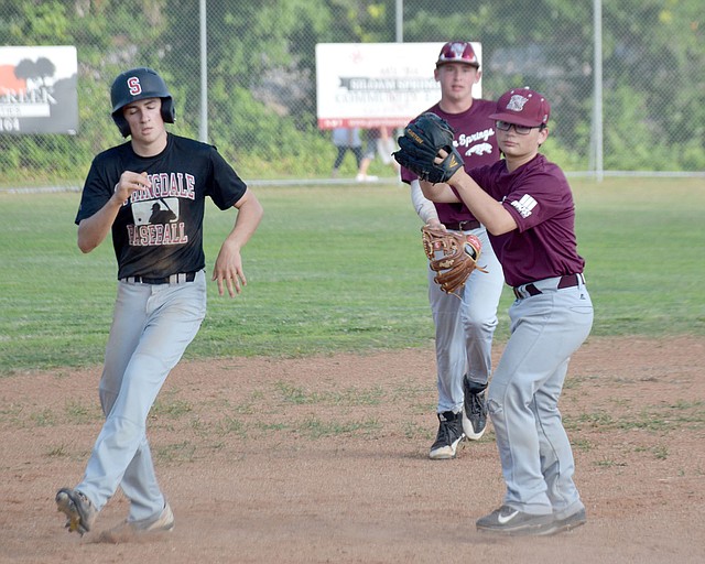Graham Thomas/Siloam Sunday Siloam Springs Post 29 third baseman Chance Wilburn tags out a Springdale baserunner during Wednesday&#8217;s game at James Butts Baseball Complex in Siloam Springs. Siloam Springs defeated Springdale 7-4.