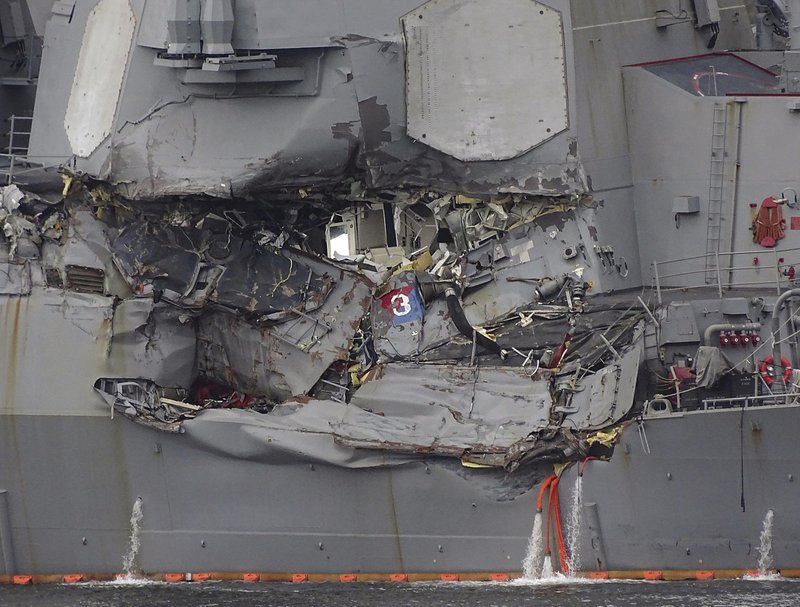 Damaged part of USS Fitzgerald is seen at the U.S. Naval base in Yokosuka, southwest of Tokyo Sunday, June 18, 2017. Navy divers found a number of sailors' bodies Sunday aboard the stricken USS Fitzgerald that collided with a container ship Saturday in the busy sea off Japan. (AP Photo/Eugene Hoshiko)