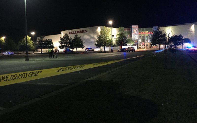 Police investigate a shooting in the parking lot of the Rave movie theater Saturday night.