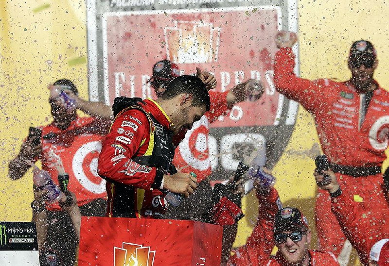 Kyle Larson celebrates Sunday afternoon after winning the NASCAR Monster Energy Cup FireKeepers Casino 400 in Brooklyn, Mich. It was Larson’s second victory of the season.