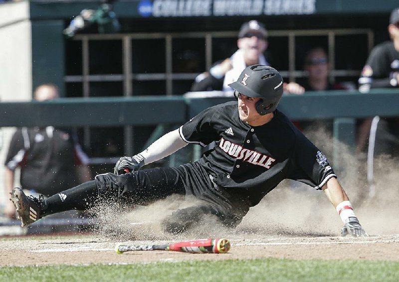 Louisville’s Ryan Summers scores on an eighth-inning single by Colby Fitch in the Cardinals’ 8-4 victory over Texas A&M at TD Ameritrade Park in Omaha, Neb.