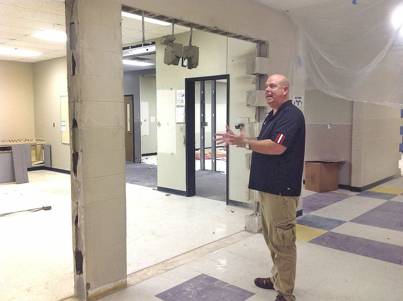 NWA Democrat-Gazette/DAVE PEROZEK Lance Arbuckle, New Technology High School principal, explains Tuesday the renovation project at this summer at the Rogers school. The school is expanding by taking over part of the Annex building occupied by the Crossroads Alternative Education Center.