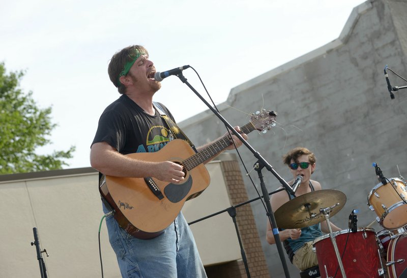 Justin Collier (left) and Tanner Mackey play with their band Surfers of the Omniverse from Springdale in the battle of the bands on Shiloh Square.