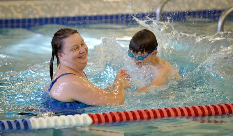 Gina Degnan of Bella Vista and her son Chase Degnan, 7, play in the leisure pool Sunday at the Bentonville Community Center.