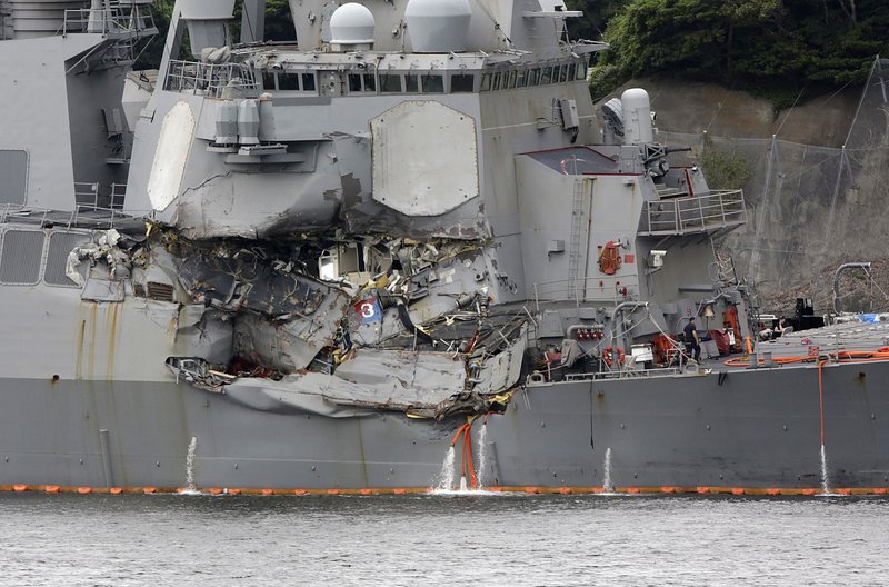 Damaged part of USS Fitzgerald is seen at the U.S. Naval base in Yokosuka, southwest of Tokyo Sunday, June 18, 2017. Navy divers found a number of sailors' bodies Sunday aboard the stricken USS Fitzgerald that collided with a container ship in the busy sea off Japan, but a spokeswoman said not all seven missing had been accounted for. 
