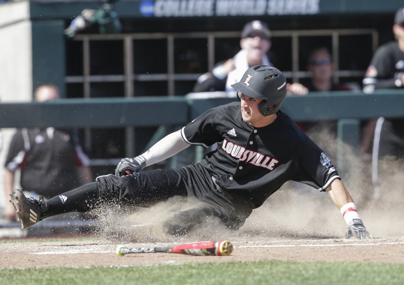 The Associated Press SLIDING IN AT HOME: Louisville's Ryan Summers scores at home on a single by Colby Fitch, who later advanced to second base on an error, in the eighth inning of a College World Series game against Texas A&M in Omaha, Neb., Sunday. Louisville won 8-4.